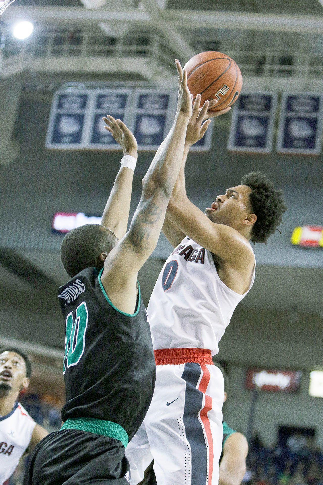 Gonzaga’s Silas Melson (0) rises to shoot as Utah Valley’s Jordan Poydras defends during the Bulldogs’ 92-69 win over the Wolverines on Friday in Spokane. (AP Photo/Young Kwak)