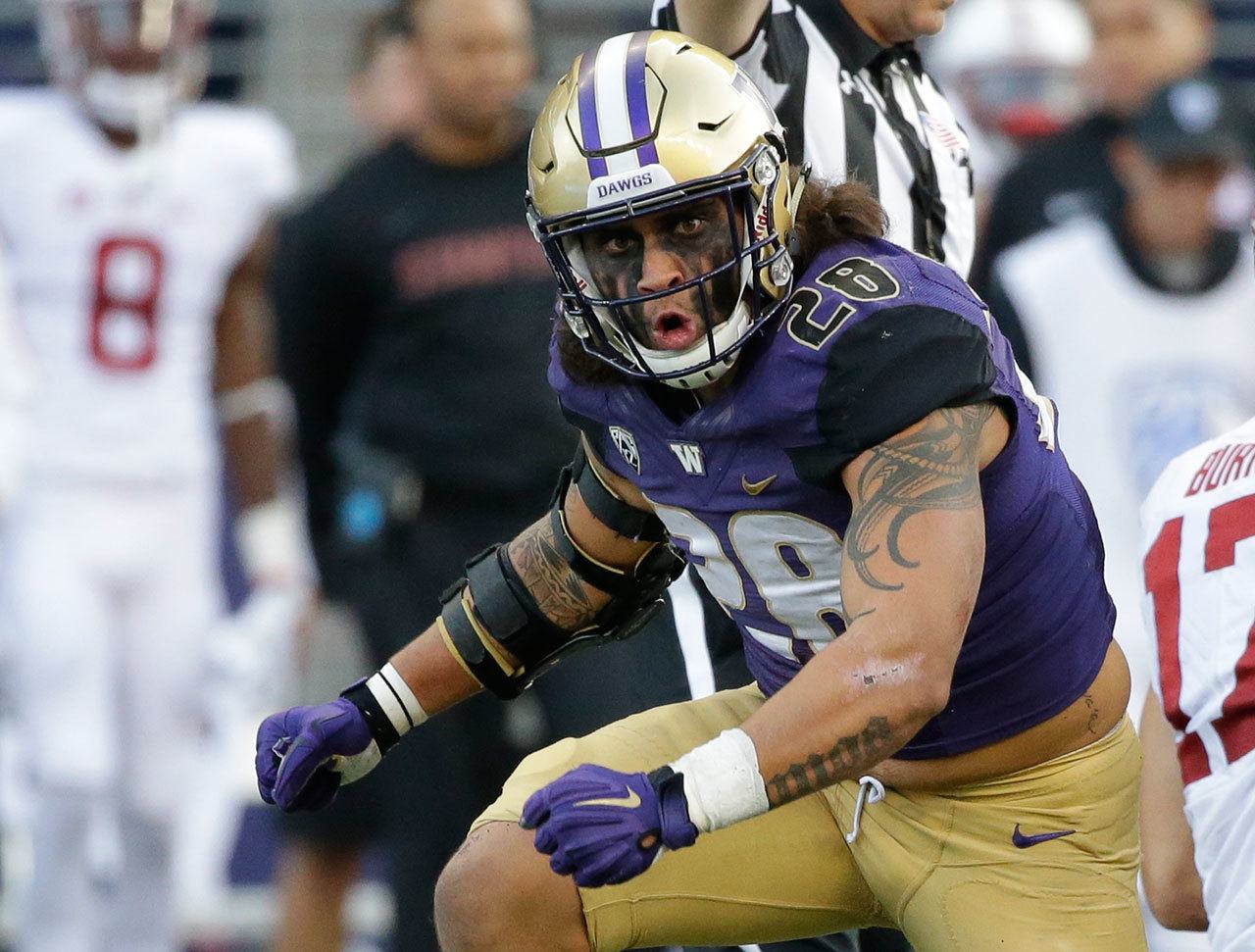 Washington linebacker Psalm Wooching celebrates after sacking Stanford quarterback Ryan Burns (not shown) during a game Sept. 30 in Seattle. (AP Photo/Ted S. Warren)
