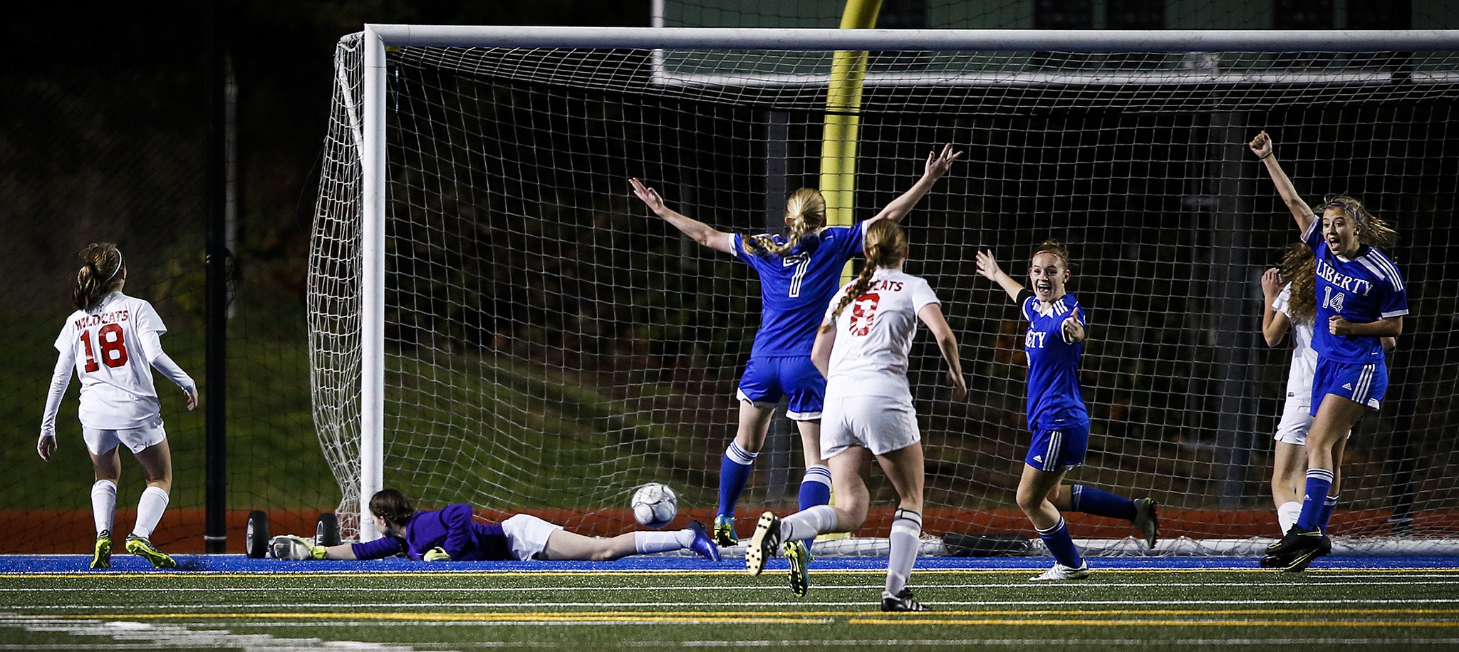 Archbishop Murphy goalkeeper Lily Zwiefel (left) lays on the turf as Liberty players celebrate a goal late in the first half of a 2A state semifinal at Shoreline Stadium on Friday. Liberty beat Archbishop Murphy 6-2. (Ian Terry / The Herald)