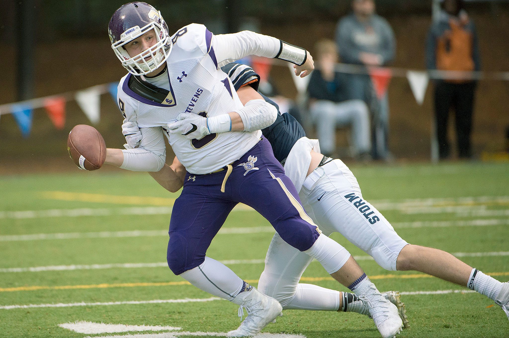 Lake Stevens quarter back Conor Bardue (8) is sacked by Skyview linebacker Cole Grossman (3) during the first quarter of a playoff game Saturday at Kiggins Bowl in Vancouver. (For The Daily Herald / Troy Wayrynen)