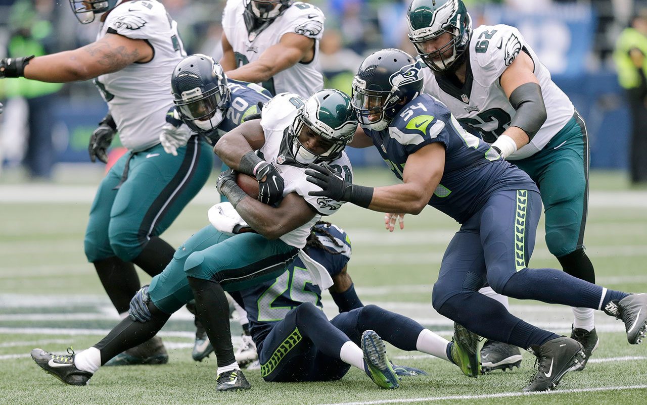 Philadelphia’s Wendell Smallwood runs the ball as Seattle’s Bobby Wagner (54) moves to make the tackle during the Seahawks’ win over tht Eagles last Sunday in Seattle. (AP Photo/Stephen Brashear)