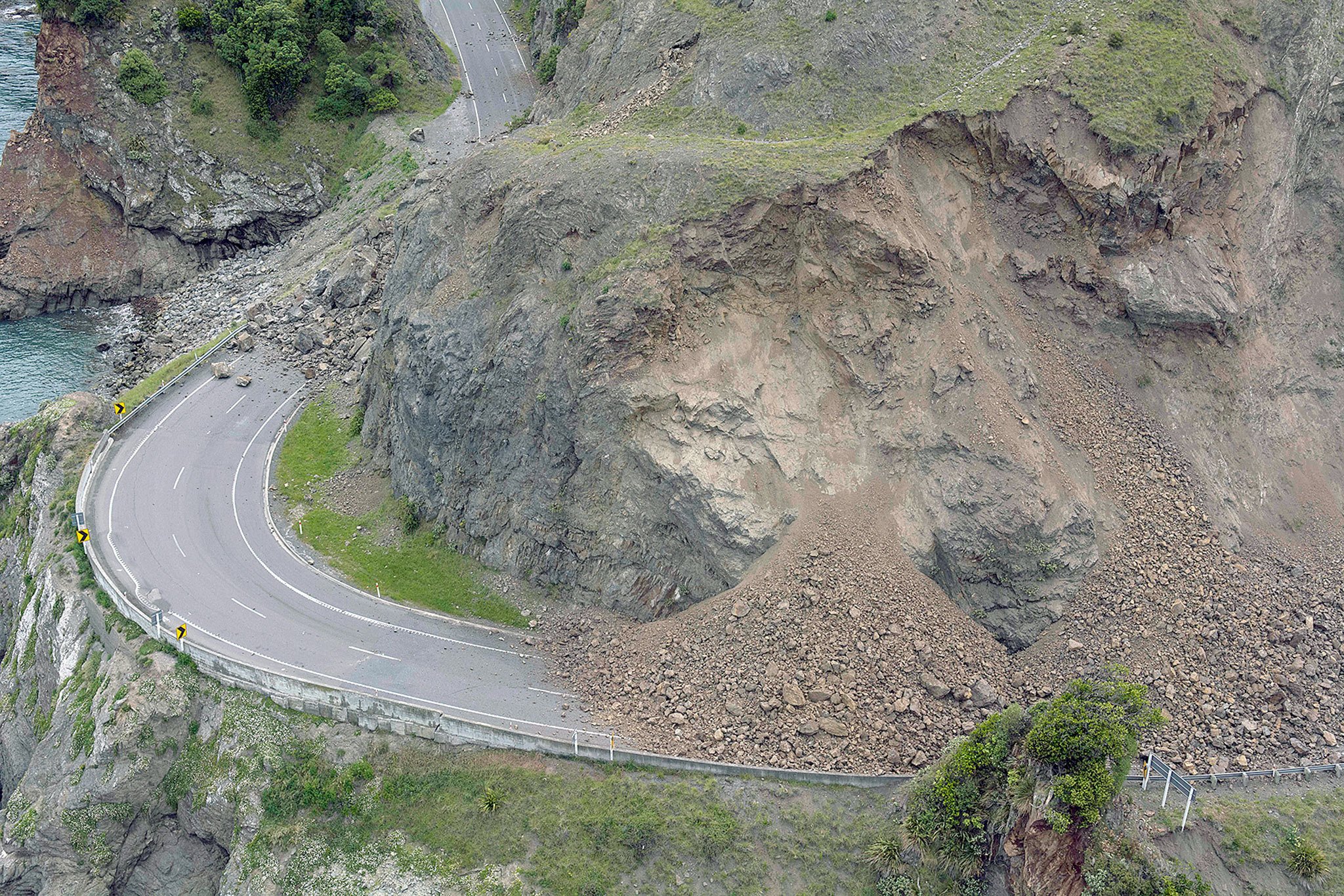 A landslide covers a section of state highway 1 near Kaikoura, New Zealand, on Monday after a powerful earthquake. (David Alexander/SNPA via AP)