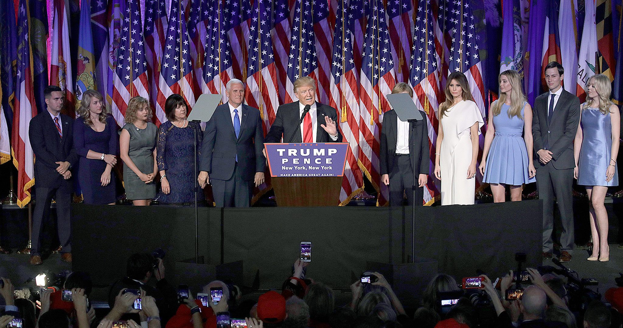 Surrounded by his family and Vice-President-elect Mike Pence and his family, President-elect Donald Trump gives his acceptance speech during an election-night rally early Wednesday in New York. (AP Photo/John Locher)