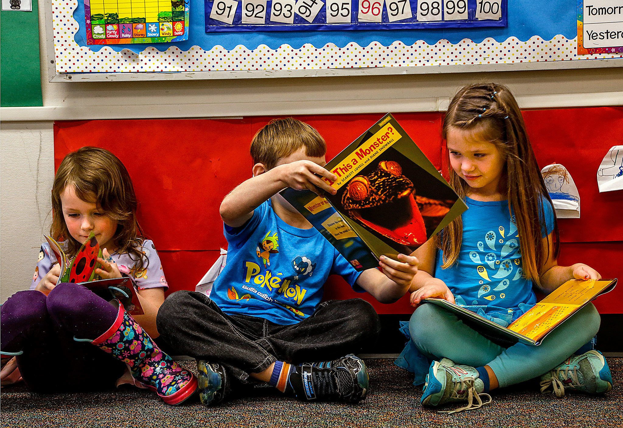 Dan Bates / The Herald                                Want to see something REALLY SCARY? Leave it to kindergarten classmate Keelan Clark to find something scary in the book “Is This a Monster?” on Thursday and show it to Hayley Whitaker while reading newly acquired books in Lisa Brizendine’s kindergarten class at Beverly Elementary School. Evelyn Holdt reads at left. The books are part of “A reading library for kindergarteners,” and include both fiction and nonfiction, Principal Danielle Sanders says.