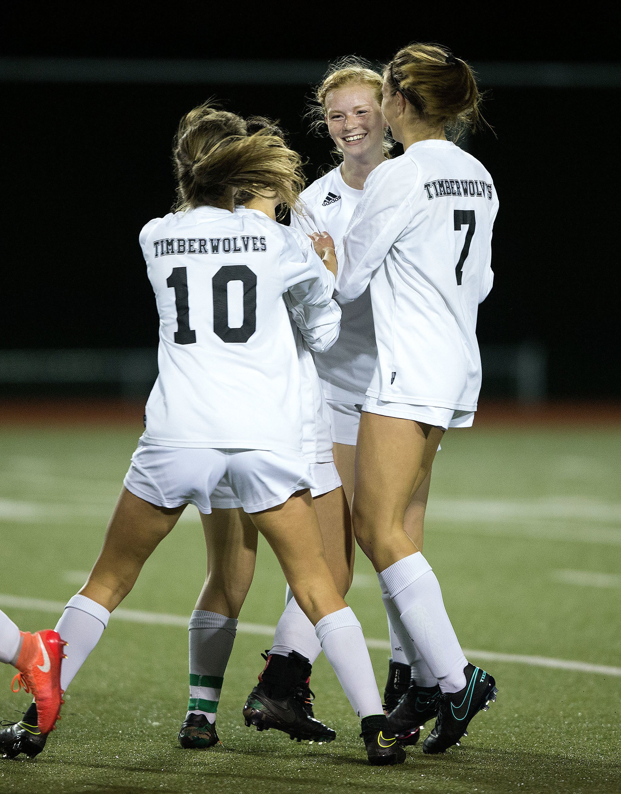 Jackson’s Rikki Myers (facing) is surrounded by teammates after scoring a goal as Jackson beat Union 2-1 in a first-round 4A state playoff game Tuesday night at Everett Memorial Stadium. (Andy Bronson / The Herald)