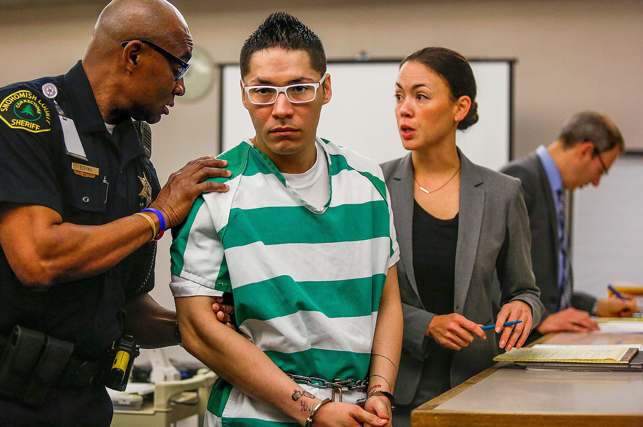 Convicted first-degree murderer Charles Courtney, with his public defender Whitney Rivera at his side, is removed from the courtroom Wednesday morning by a Snohomish County deputy following sentencing for the shooting of 16-year-old Anthony Boro. Courtney didn’t know the victim, and bragged about having made his first confirmed kill, according to deputy prosecutor Jarett Goodkin (far right). (Dan Bates / The Herald)