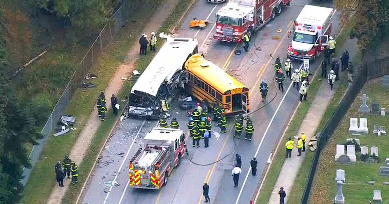 In this view from video, emergency personnel work at the scene of a fatal crash of a school bus and a commuter bus in Baltimore on Tuesday. (WBAL-TV via AP)