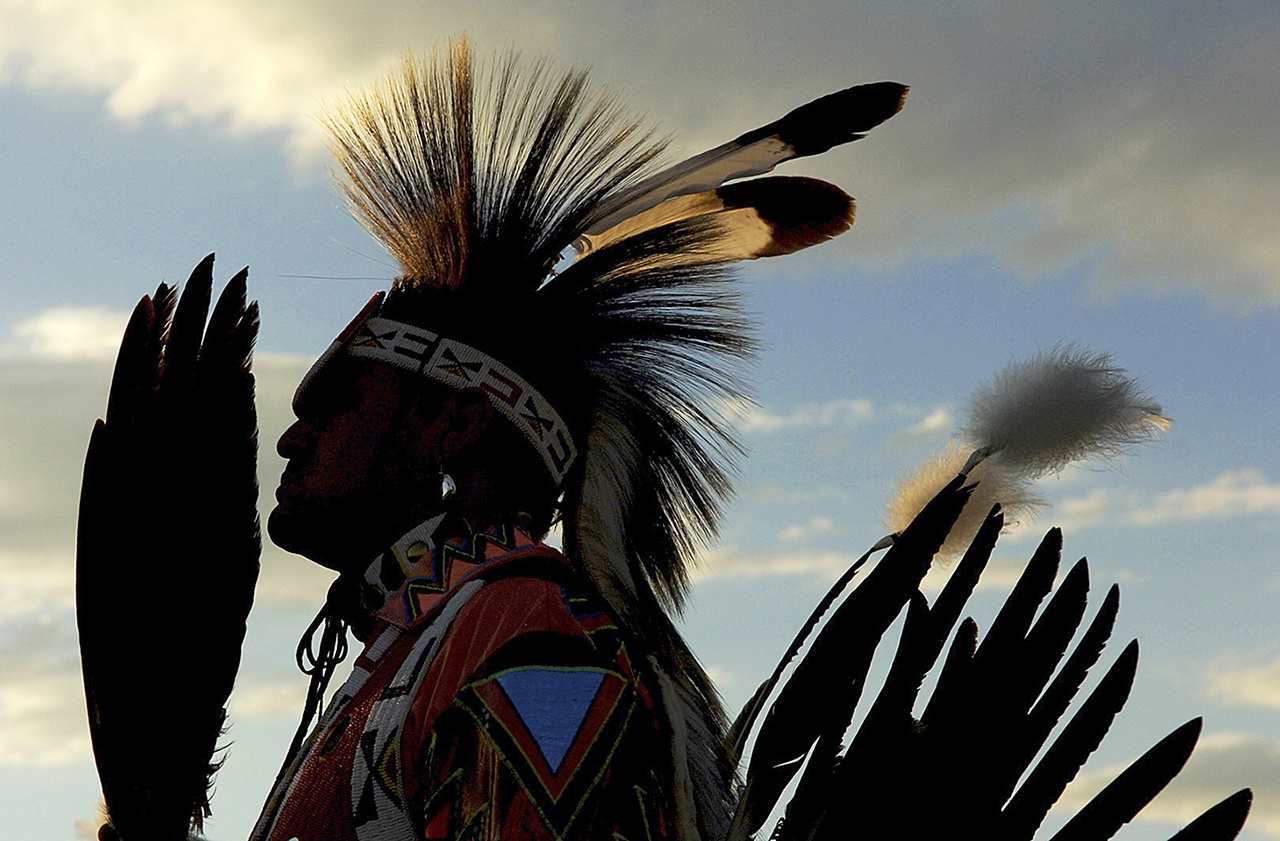 In this Aug. 12, 2006, photo, David Lee, a member of the Shoshone-Bannock tribe, pauses between ceremonial dances at the Shoshone-Bannock Indian Festival in Fort Hall, Idaho. U.S. officials say a program to return land on American Indian reservations to tribal control likely will run out of money before millions of eligible acres are addressed. (Ben Fredman/The Idaho Post-Register via AP, File)