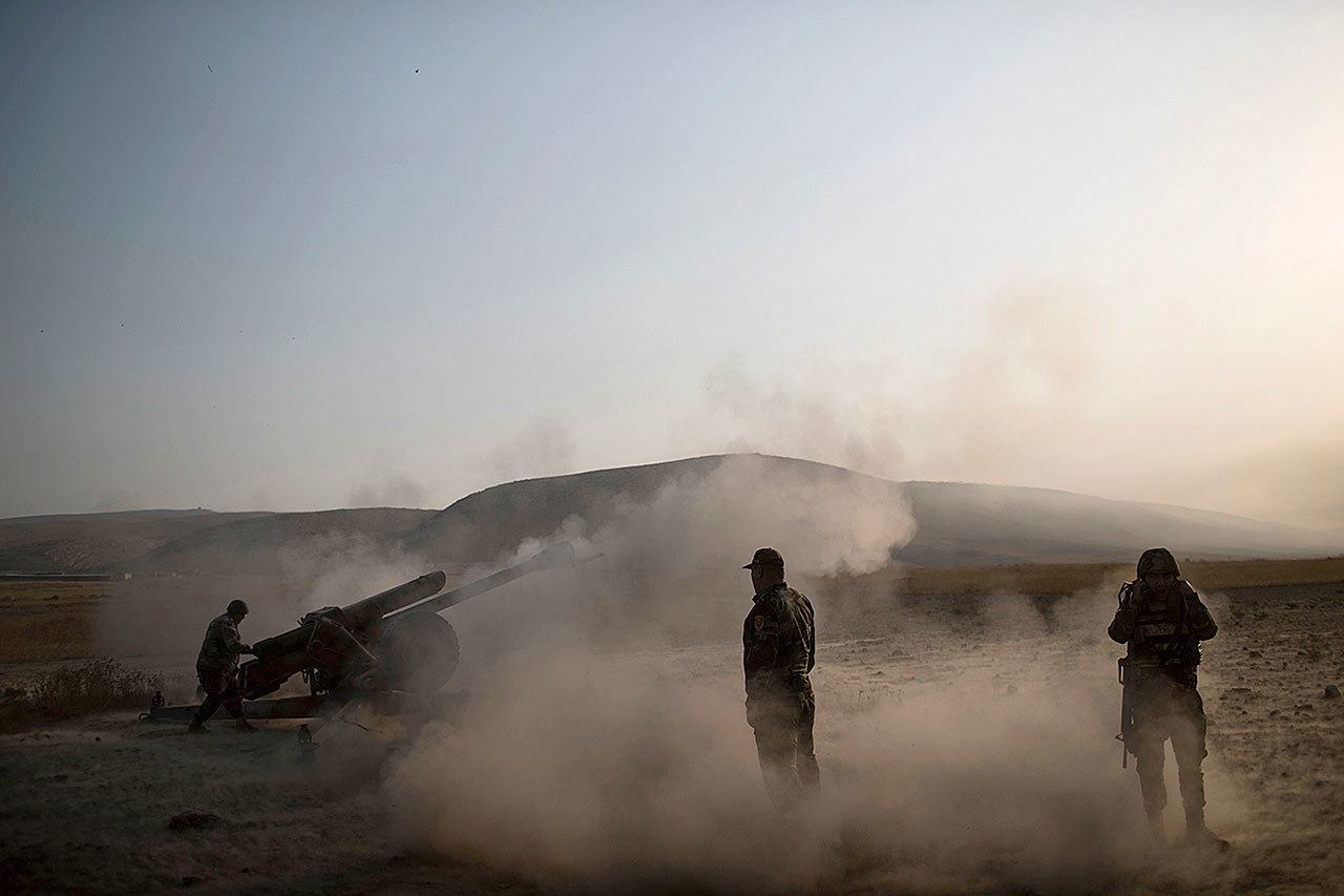 Kurdish Peshmerga soldiers fire artillery at Islamic State positions in Bashiqa, east of Mosul, Iraq, on Monday, Nov. 7. Iraqi Kurdish fighters exchanged heavy fire with IS militants early Monday as they advanced from two directions on a town held by the Islamic State group east of the city of Mosul. (AP Photo/Felipe Dana)