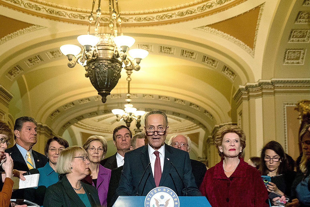 Sen. Chuck Schumer, D-N.Y. (center), accompanied by the Senate Democrats, speaks to reporters on Capitol Hill in Washington on Wednesday, Nov. 16, after being chosen Senate Minority Leader for the 115th Congress. From left are, Sen. Joe Manchin, D-W.Va., Sen. Amy Klobuchar, D-Minn., Sen. Patty Murray, D-Wash., Sen. Elizabeth Warren, D-Mass., Sen, Mark Warner, D-Va., Senate Minority Whip Richard Durbin of Ill., Schumer, Sen. Bernie Sanders, I-Vt., and Sen. Debbie Stabenow, D-Mich. (AP Photo/Andrew Harnik)