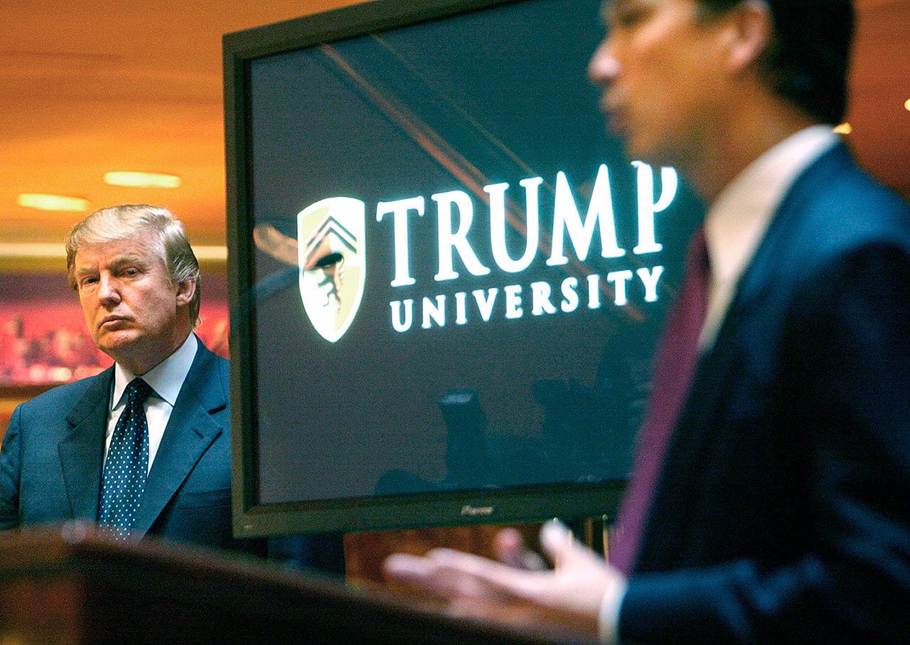 In this 2005 photo, then real estate mogul and Reality TV star Donald Trump listens as Michael Sexton introduces him at a news conference in New York where he announced the establishment of Trump University. (AP Photo/Bebeto Matthews, File)