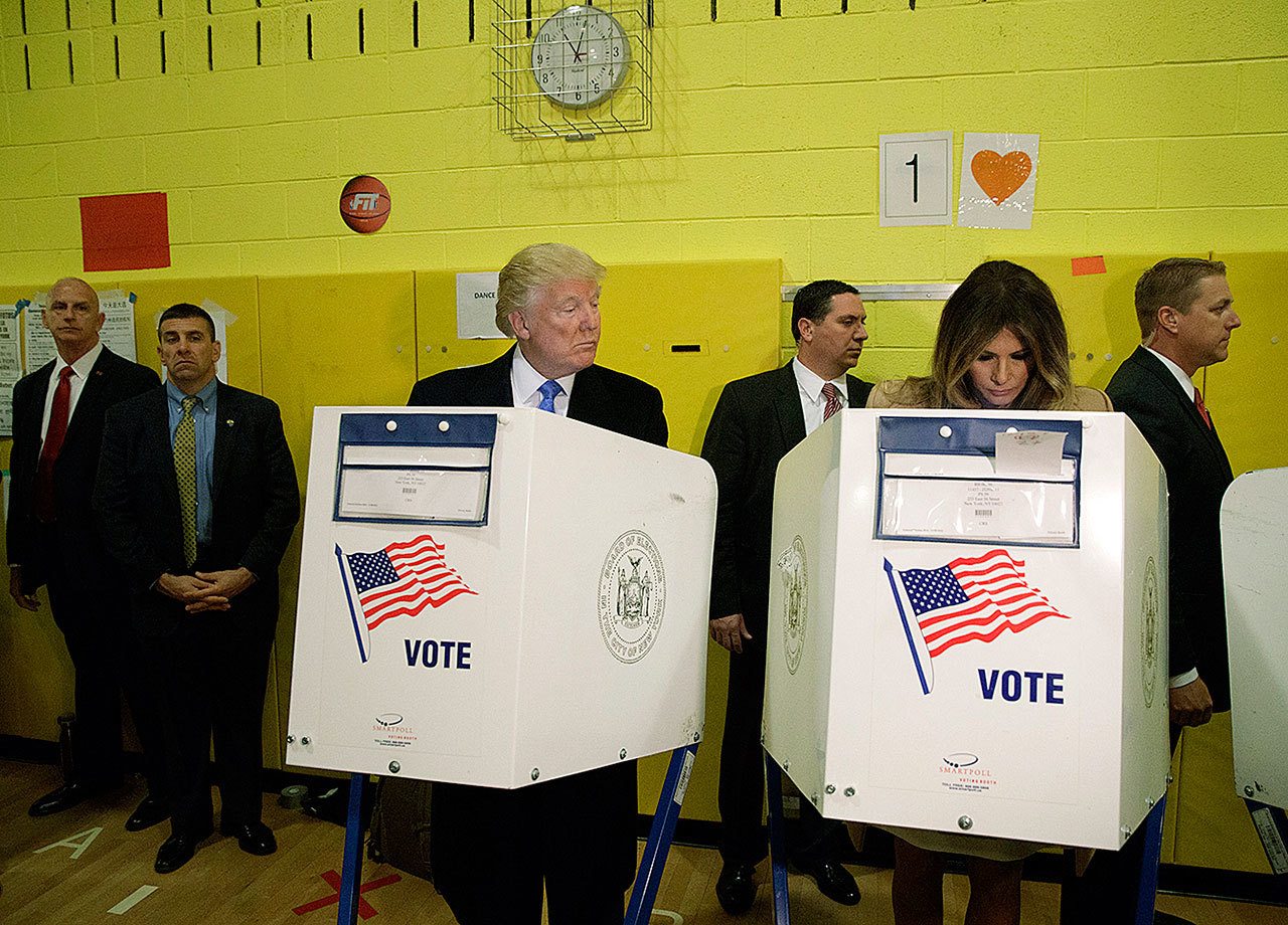 Republican presidential candidate Donald Trump looks at his wife Melania as they cast their votes at PS-59 on Tuesday, Nov. 8, in New York. (AP Photo/ Evan Vucci)
