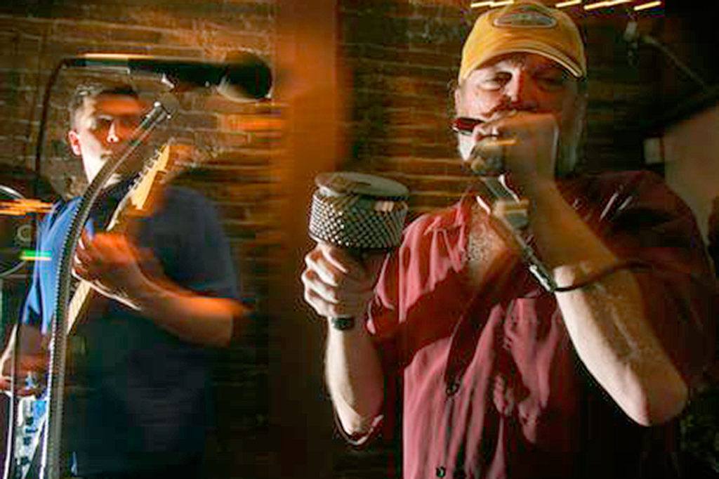 Harmonica play Jeff Nicely (right) and guitarist Roger Enders play blues late into the night at the Horseshoe Saloon on Hewitt Avenue in Everett in 2005. Nicely will host the Legends of the Blues IV in Arlington on Saturday. (Herald file photo)
