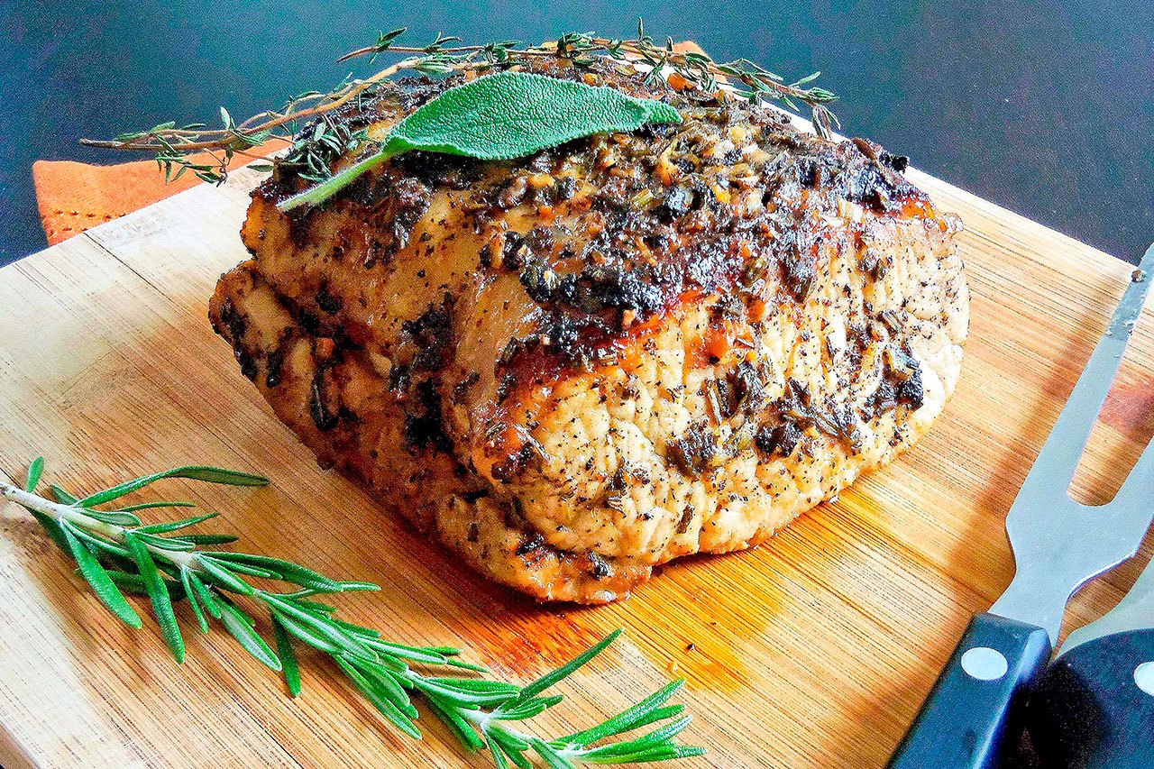 Herb-crusted pork loin is a juicy alternative for Thanksgiving. (Dana Cizmas / Pittsburgh Post-Gazette)