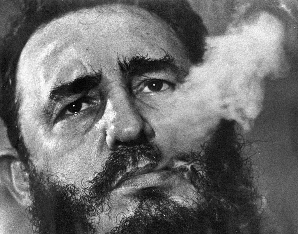 March 1985: Cuba’s leader Fidel Castro exhales cigar smoke during an interview at the presidential palace in Havana, Cuba. (AP Photo/Charles Tasnadi, File)
