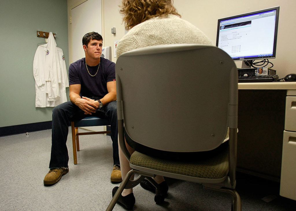 Jordan Finley listens to Dr. Lisa McPeak during his Traumatic Brain Injury (TBI) screening at the Center for Polytrauma Care at the VA Puget Sound Health Care System in Seattle in 2011. Jordan sustained a concussion while serving in Afghanistan. Finley now lives in Louisville, Kentucky, and is studying for a master’s degree in divinity. (Sarah Weiser / The Herald)
