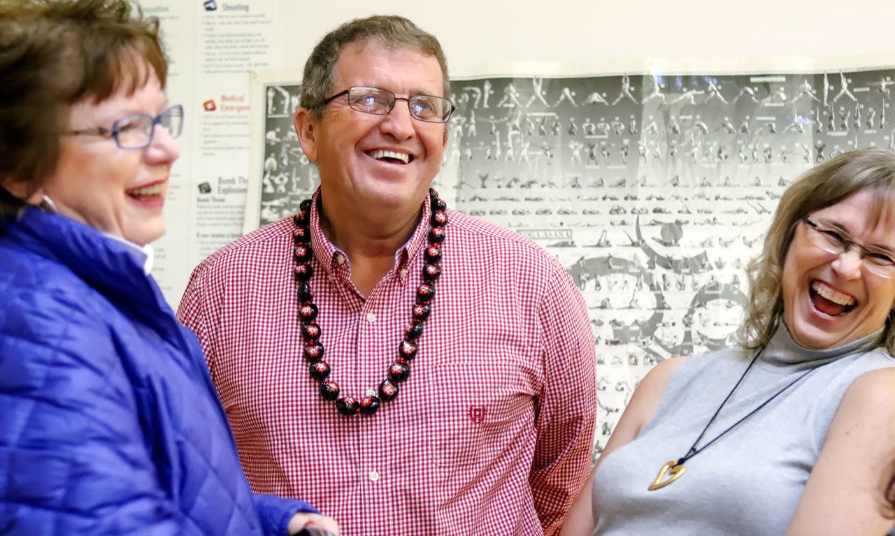 From left to right, Barbara Haldi, Larry Walker and Carey Walker share a laugh before the start of Larry Walker’s retirement party at the Walt Price Student Fitness Center in Everett on Nov. 9. Larry Walker, athletic director and men’s basketball coach at Everett Commuinty College, is retiring after 31 years. (Kevin Clark / The Herald)