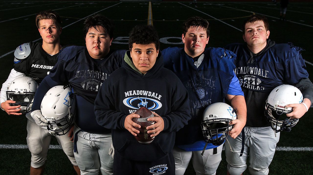 Meadowdale’s starting offensive line Alex Maxwell, (L-R) Eric Lee, Thomas Cheeney, Brendan Diaz and Bryce Chapman never played their assigned positions before this year. The starting five have be crucial to the Maverick’s success as they prepare for their 3A state semifinal. (Kevin Clark / The Herald)
