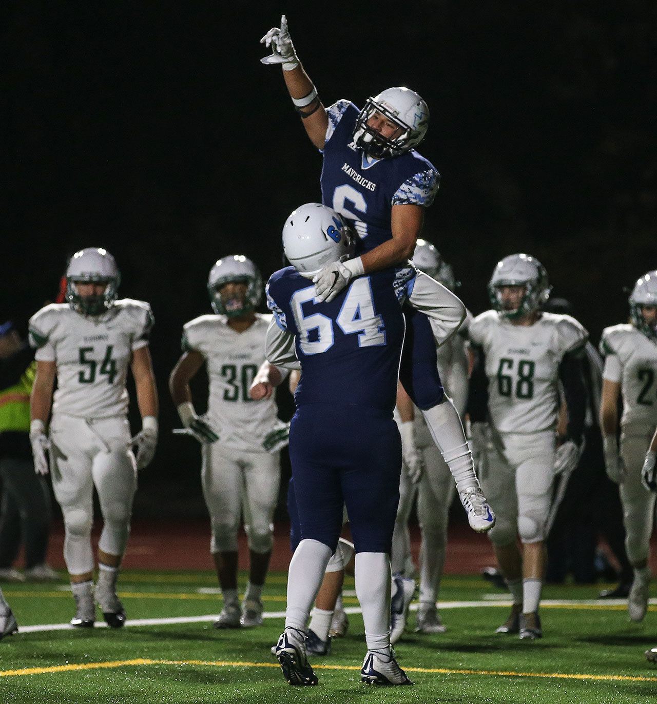 Meadowdale’s Kela Marshall (6) celebrates a touchdown with teammate Bryce Chapman during a 3A state quarterfinal game against Peninsula on Friday at Edmonds Stadium. (Kevin Clark / The Herald)