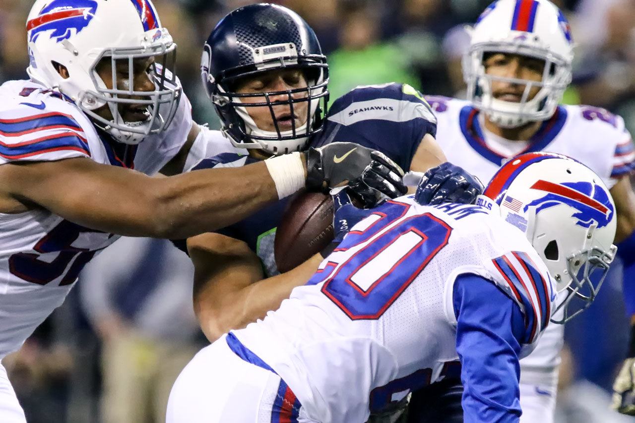 Seahawks tight end Jimmy Graham is tackled by Bills linebacker Lerentee McCray (left) and safety Corey Graham after a reception during Seattle’s 31-25 win over Buffalo on Monday in Seattle. (Kevin Clark / The Herald)