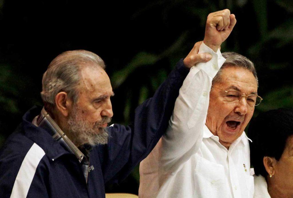 April 19, 2011: Fidel Castro (left) raises his brother’s hand, Cuba’s President Raul Castro, as they sing the anthem of international socialism during the 6th Communist Party Congress in Havana, Cuba. (AP Photo/Javier Galeano, File)
