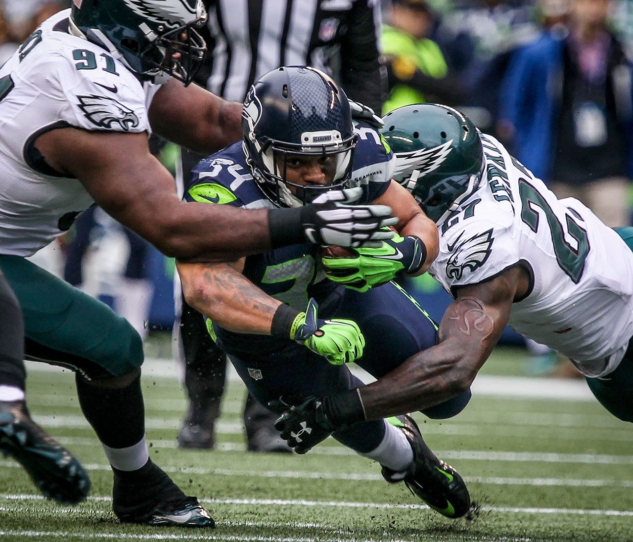 Seahawks running back Thomas Rawls dives to split defenders Eagles defensive lineman Fletcher Cox, left, and Eagles safety Malcolm Jenkins Sunday afternoon at Century Link Field in Seattle on November 20, 2016. Seahawks won 26-15. (Kevin Clark / The Herald)
