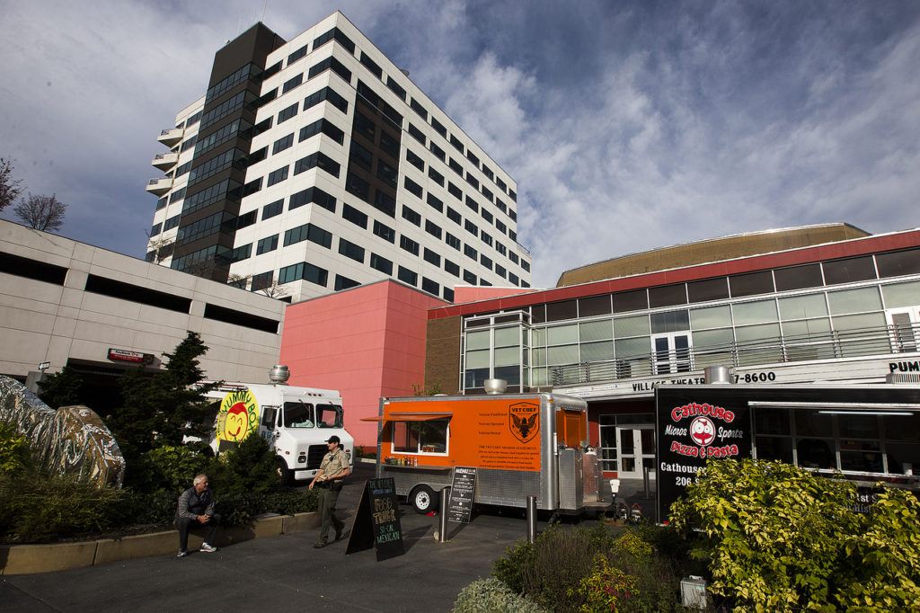 Food trucks (from left) Yummy Box, The Vet Chef and Cathouse Pizza share a space near the Everett Performing Arts Center in downtown Everett on Friday. (Ian Terry / The Herald)
