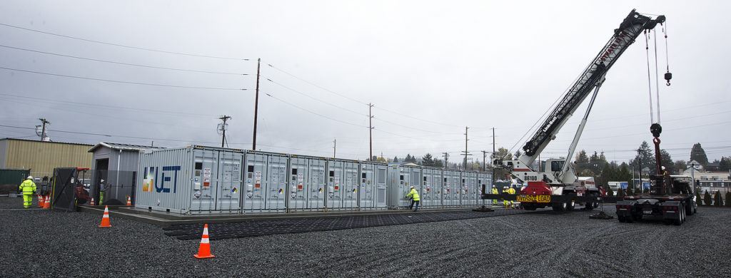 A crane sits next to a row of vanadium flow batteries at the PUD’s Everett Substation. (Ian Terry / The Herald)
