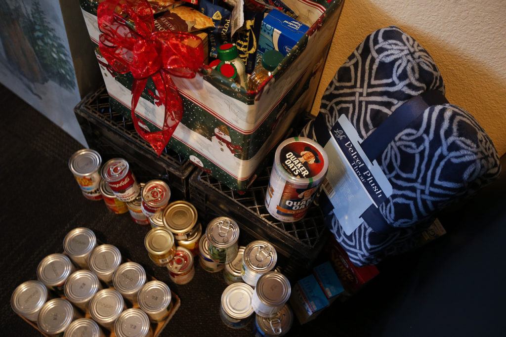 Donations for the local food bank pile up during a Thanksgiving feast at The Hawks Nest in Darrington on Thursday, Nov. 24. (Ian Terry / The Herald)
