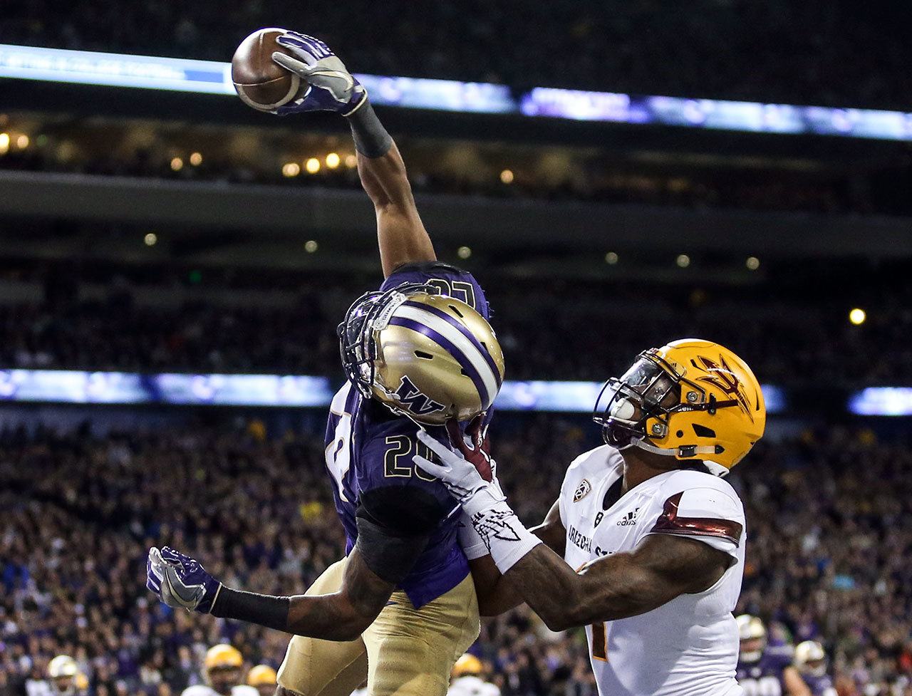 Washington defensive back Kevin King intercepts a pass in the end zone intended for Arizona State’s N’Keal Harry Saturday at Husky Stadium in Seattle. (Kevin Clark / The Herald)