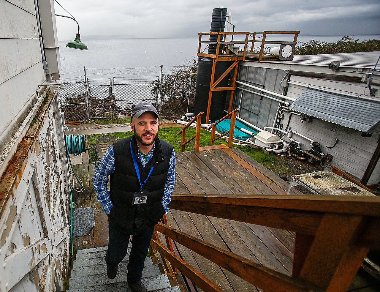 Barney Boyer climbs a back stairway to the unique workplace on Puget Sound that is the Mukilteo Research Station of NOAA’s Northwest Fisheries Science Center. Boyer, 35, is the first military veteran to become an intern with NOAA Fisheries through a new partnership. (Dan Bates / The Herald)