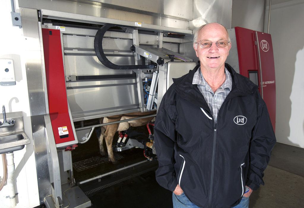 Larry Stap, owner of Twin Brook Creamery, stands by the automated milking machine. (Andy Bronson / The Herald)
