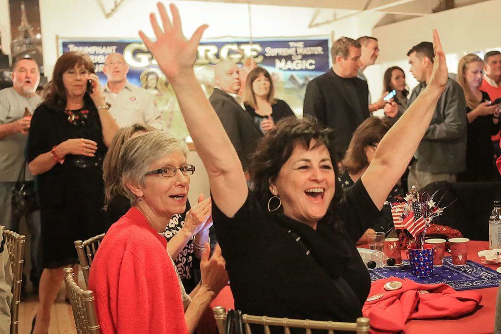Republican supporters react to numbers coming in at the Snohomish Event Center on Tuesday. (Kevin Clark / The Herald)
