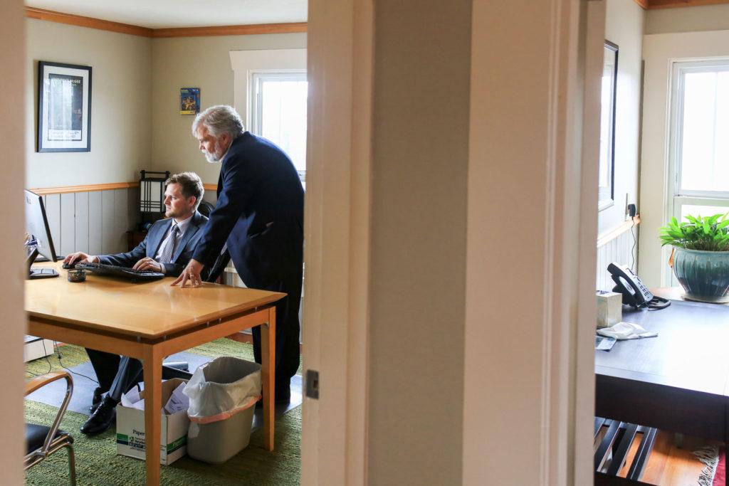 Ben Neeleman, left, with his dad Thomas Neeleman review files at their office, Neeleman Law Group, in Marysville on October 19, 2016. (Kevin Clark / The Herald)
