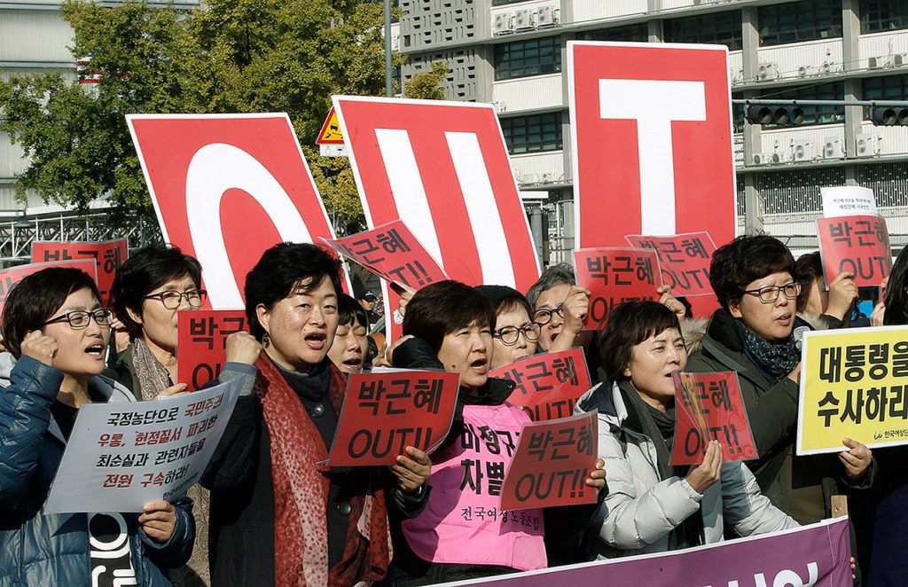 South Korean protesters shout slogans during a rally calling for South Korean President Park Geun-hye to step down in downtown Seoul, South Korea, on Thursday, Nov. 3. South Korean prosecutors detained a former senior aide of Park as they widen their investigation into a snowballing scandal centering on whether the president’s close friend controlled the government from the shadows, officials said Thursday. Placards read: “Park Geun-hye Out.” (AP Photo/Ahn Young-joon)
