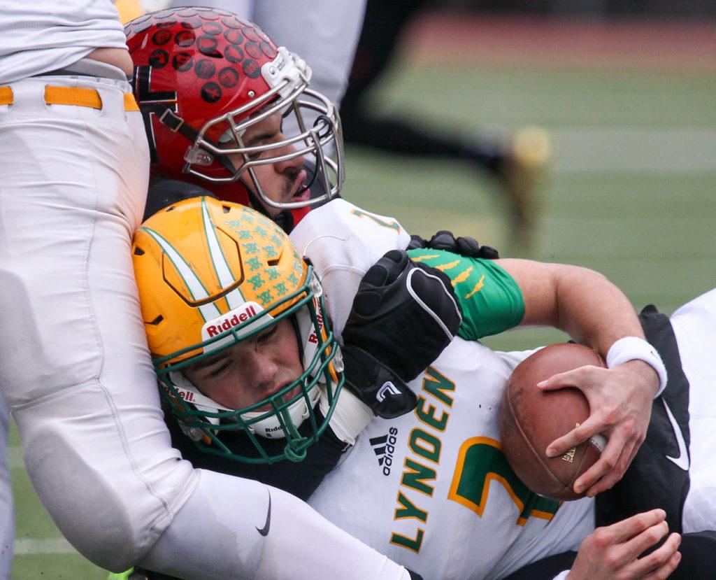 Archbishop Murphy’s Abraham Lucas sacks Lynden’s Jacob Hommes during a 2A state semifinal game Saturday afternoon at Everett Memorial Stadium. The Wildcats won 52-14. (Kevin Clark / The Herald)
