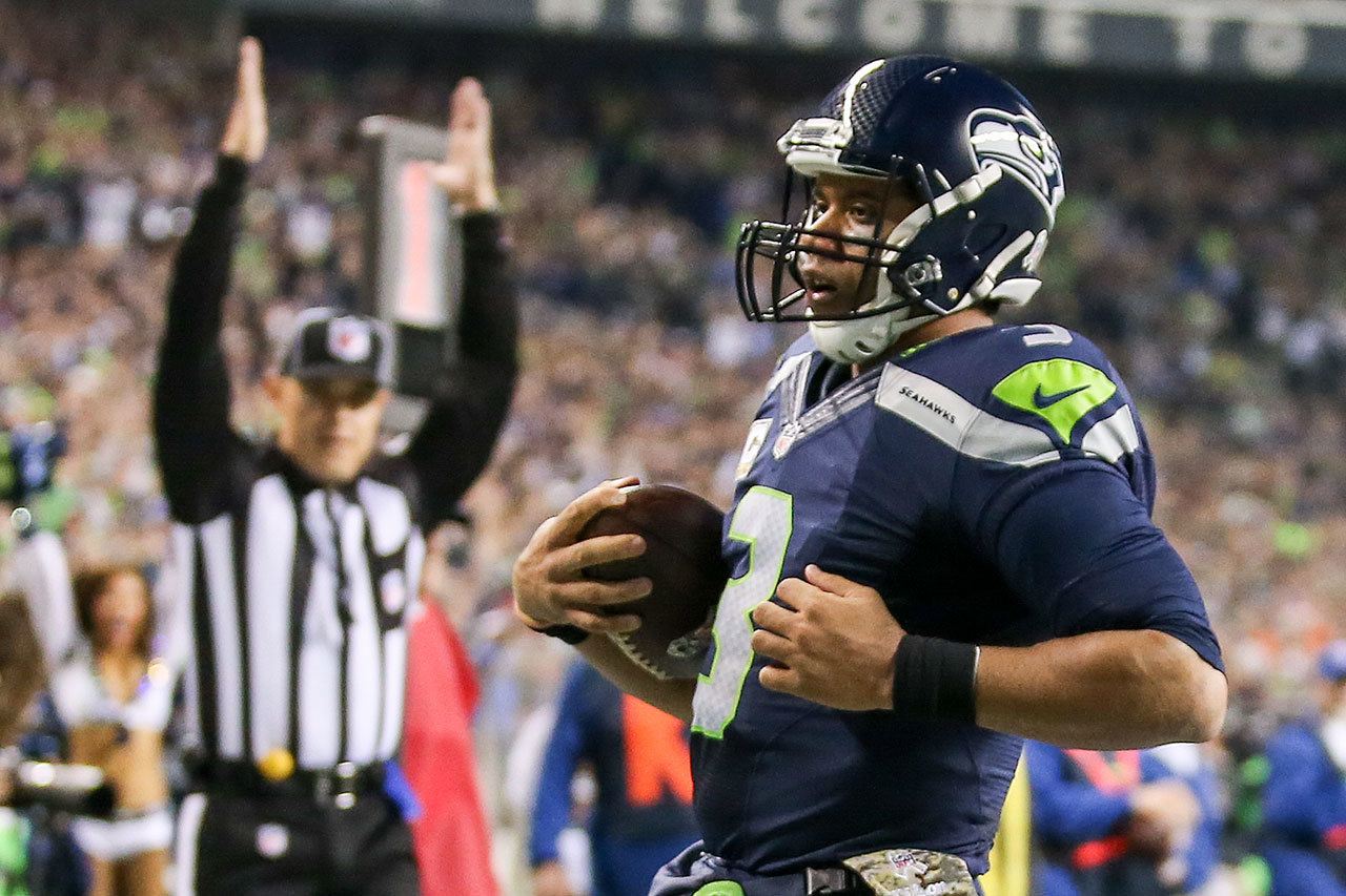 Seahawks quarterback Russell Wilson rushes for a touchdown in the first quarter of Seattle’s 31-25 win over Buffalo on Monday night in Seattle. (Kevin Clark / The Herald)