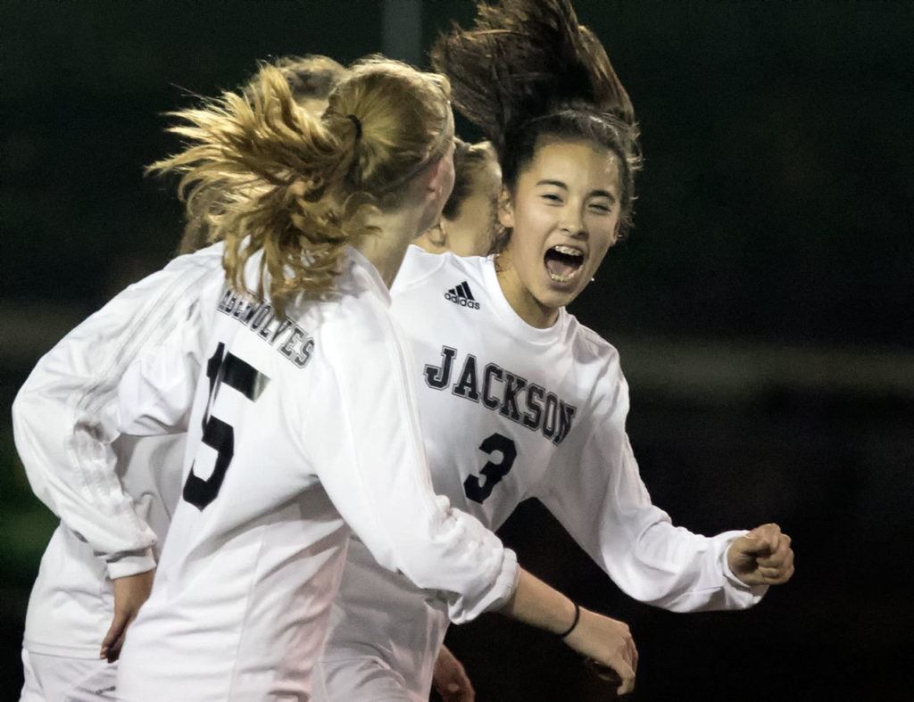 Jackson’s Katie Cheng (3) celebrates with teammate Alyssa Weed after Cheng’s goal during a district playoff match Thursday night at Everett Memorial Stadium. (Kevin Clark / The Herald)

