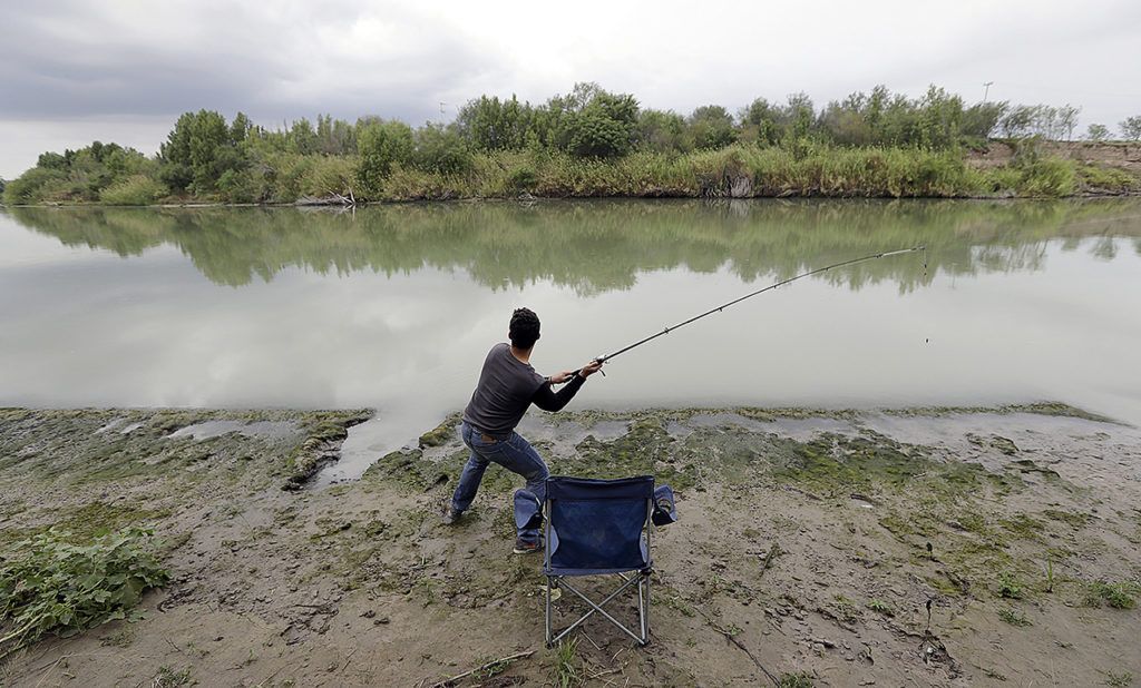 In this Nov. 12, photo, Isac Ramos fishes at a ranch on the banks of the Rio Grande in Los Ebanos, Texas. The area would be cut of if a border wall is build in the area. (AP Photo/Eric Gay)
