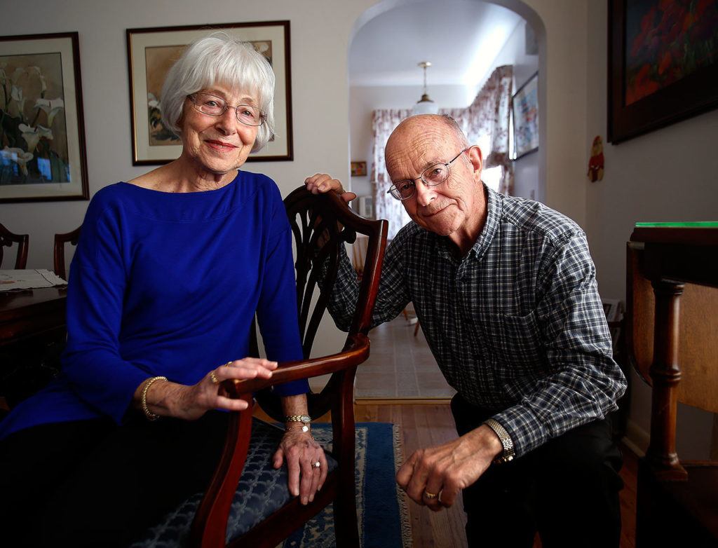 Retired educators, Ed and Betty Morrow, both in their 80s, relax at their home in Everett. (Dan Bates / The Herald)
