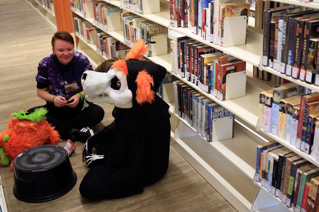 Peter Klein (left) and Ashen Wilson take a break during the Sno-Isle ComicCon on Sunday morning at the Snohomish Library. (Kevin Clark / The Herald)
