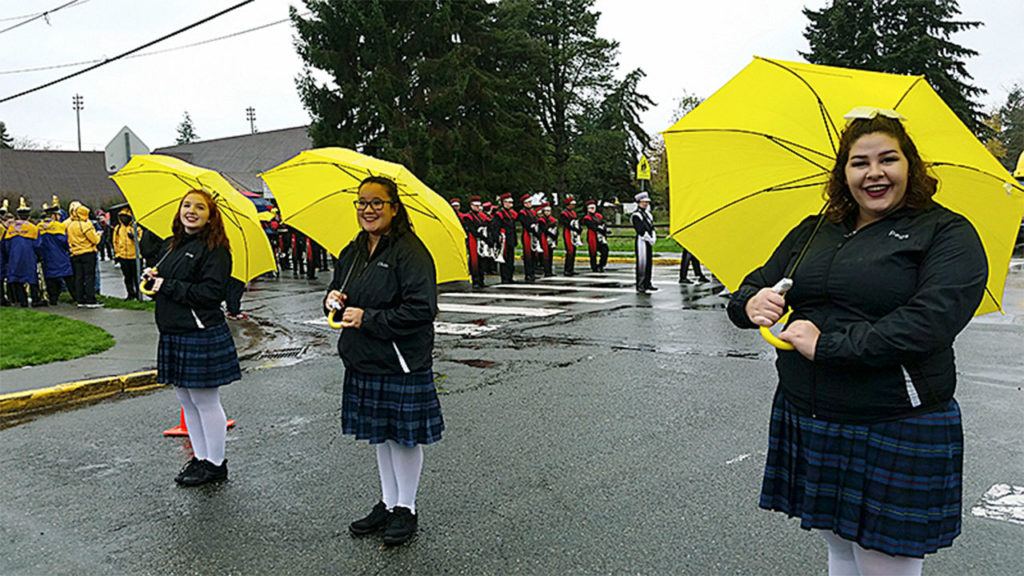 Cascade High School Cascade Sound color guard members (from left) Sidney Landrie, Chelsea Crumbaugh and Peggy Grounds warm up for a parade performance. The group later held their final show with the marching band on Nov. 5 at the Auburn High School Veterans Day Marching Band Championships and won first place. (Contributed photo)
