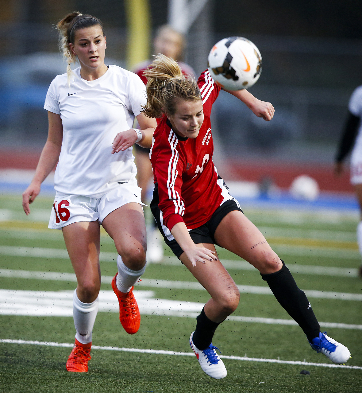 Stanwood’s Bailey Post (left) and Snohomish’s Quinn Otteson battle for a loose ball during a district playoff game Tuesday at Shoreline Stadium. (Ian Terry / The Herald)
