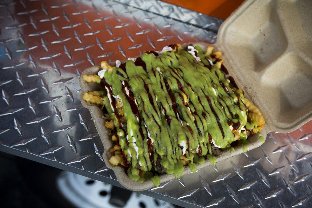 Carne Asada “Nacho Fries” from Vet Chef were on of many offerings from three local food trucks in downtown Everett on Friday. (Ian Terry / The Herald)
