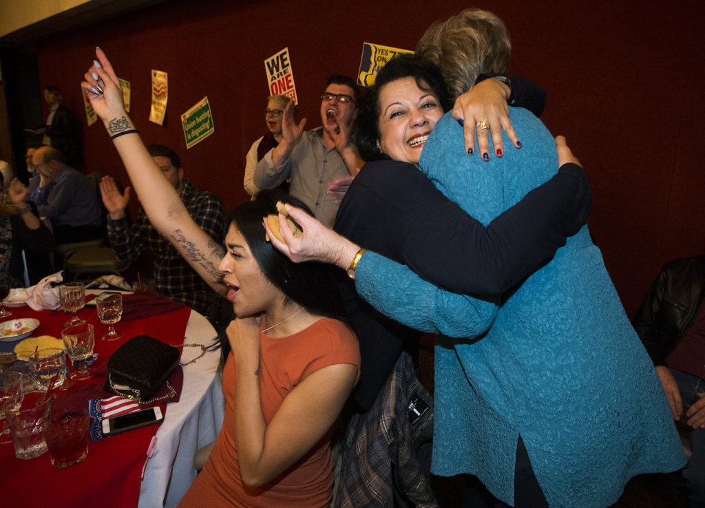 Ian Terry / The Herald State Representative Lillian Ortiz-Self (center) hugs Mary Helen Roberts as Priscilla Marin (left) cheers after results came in showing Ortiz-Self leading her race during a democrat viewing party at Nile Shriners in Mountlake Terrace on Tuesday, Nov. 8. Photo taken on 11082016
During a Democratic party at Nile Shriners in Mountlake Terrace on Tuesday, 21st District state Rep. Lillian Ortiz-Self (center) hugs Mary Helen Roberts after hearing results that Ortiz-Self was leading in her bid for re-election. (Ian Terry / The Herald)
