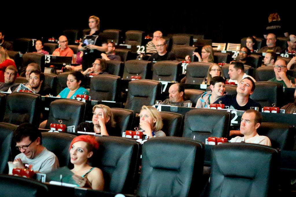 Movie goers watch the pre-preview show at Cinebarre. (Kevin Clark / The Herald)
