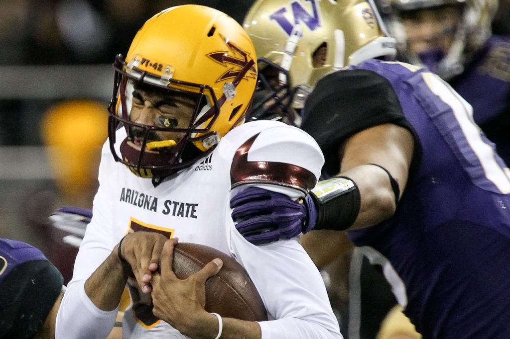 Arizona State’s Manny Wilkins is sacked by Washington linebacker DJ Beavers Saturday at Husky Stadium in Seattle. (Kevin Clark / The Herald)

