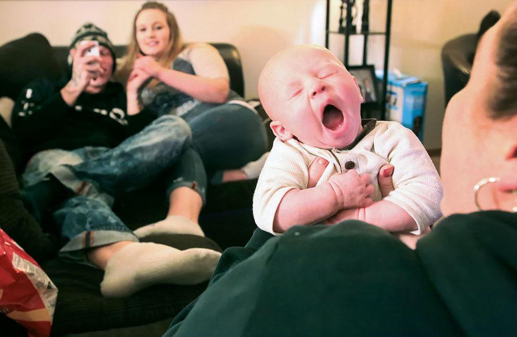 Jessica Warren holds her grandson, Brayden Varnes, while parents Jacob Varnes and Jessiana King look on at Warren’s home in Granite Falls. (Kevin Clark / The Herald)
