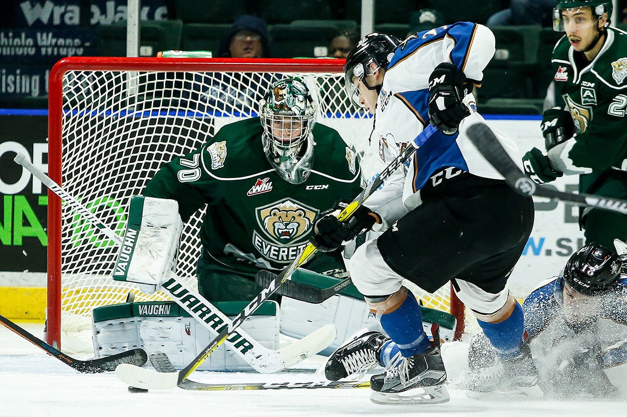 Silvertips goalie Carter Hart (70) eyes the puck as Kootenay’s Zak Zborosky skates in front of the net during a game at Xfinity Arena in Everett on Nov. 30. (Ian Terry / The Herald)