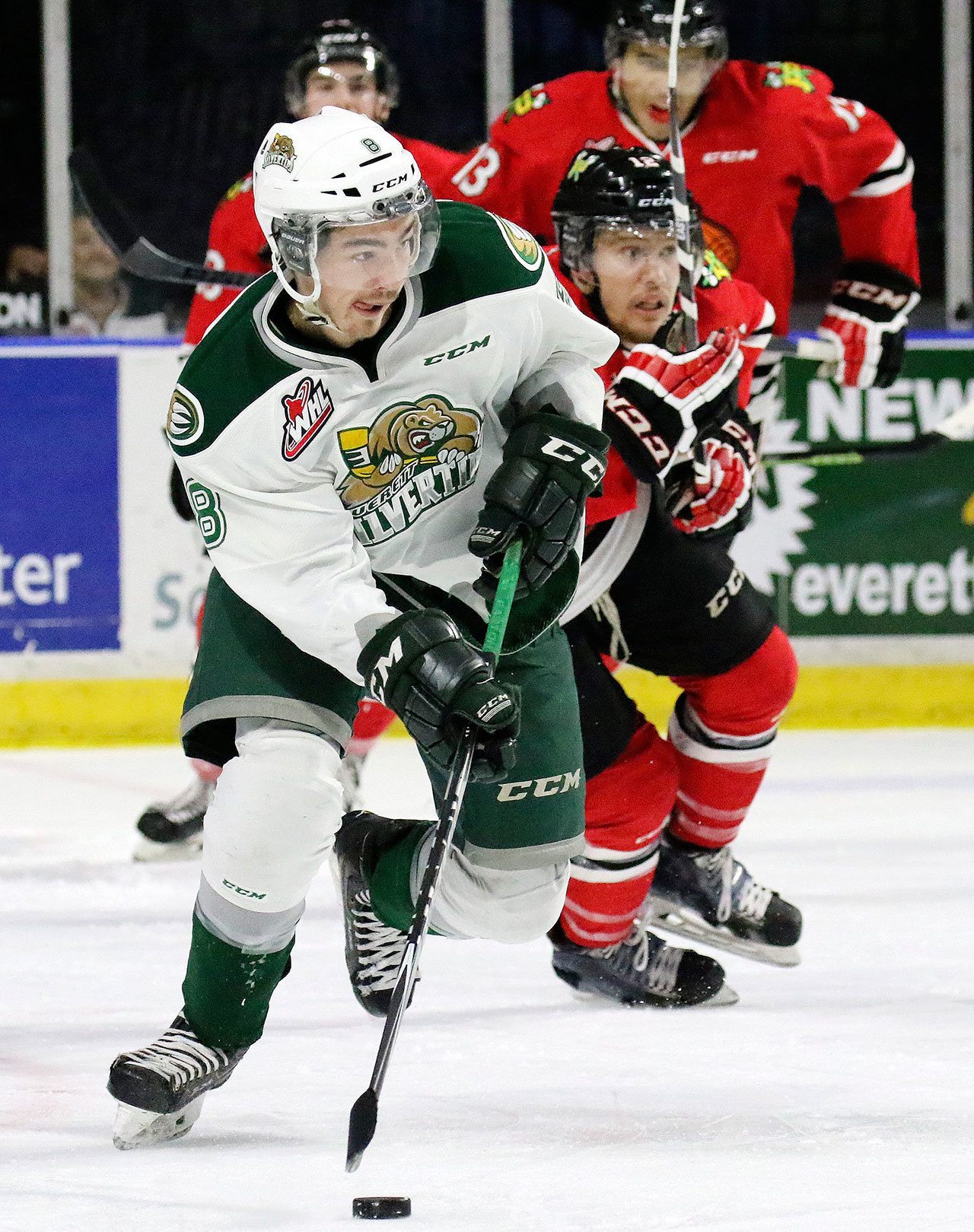 The Silvertips’ Patrick Bajkov handles the puck in front of the Winterhawks’s Miles Koules during a game last season at Xfinity Arena in Everett. (Kevin Clark / The Herald)